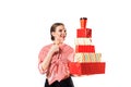 Young woman hold gift box . Smiling happy girl on white background. A large lot of red boxes. Girl at a party, birthday Royalty Free Stock Photo