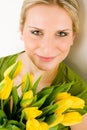 Young woman hold yellow tulips flower