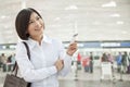 Young Woman Holding an Airplane Ticket