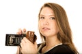 Young woman holding an antique camera with a serious expression Royalty Free Stock Photo