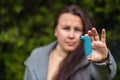 Young woman holding an astma inhaler against attacks in her hands, healthcare concept Royalty Free Stock Photo