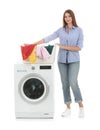 Young woman holding basket with dirty laundry near washing machine Royalty Free Stock Photo