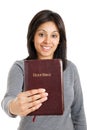 Young woman holding a bible showing commitment
