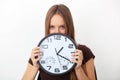 Young woman holding big wall clocks on white background.