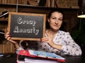 Young woman holding a black chalkboard in hands. Conceptual photo about Group Annuity with written text