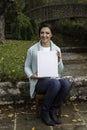 Young woman holding a blank canvas