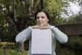 Young woman holding a blank canvas