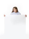 Young woman holding blank white sign board in casual clothing. Isolated studio portrait. Royalty Free Stock Photo