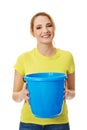 Young woman holding blue bucket. Royalty Free Stock Photo