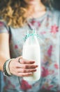 Young woman holding bottle of dairy-free almond milk with straw Royalty Free Stock Photo