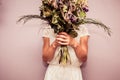 Young woman holding bouquet of dead flowers Royalty Free Stock Photo