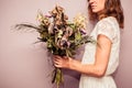 Young woman holding bouquet of dead flowers Royalty Free Stock Photo
