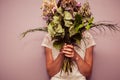 Young woman holding bouquet of dead flowers Royalty Free Stock Photo