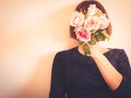 Faceless female portrait with flowers covering her face