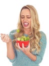 Young Woman Holding a Bowl of Brussels Sprouts Disgusted