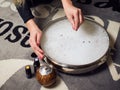 Young woman holding a bowl filled with a bath of essential oils, while she scatters it with lavender flowers, next to it there are Royalty Free Stock Photo