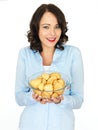 Young Woman Holding a Bowl of Roast Potatoes Royalty Free Stock Photo