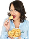 Young Woman Holding a Bowl of Roast Potatoes Royalty Free Stock Photo