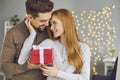 Young woman holding box with Valentine present and thanking her boyfriend for the gift Royalty Free Stock Photo