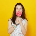 Young woman holding bright candy Royalty Free Stock Photo