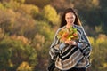 Young woman holding bunch of autumn leaves. Natural beauty. Fear of aging concept