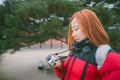 Young woman holding camera in hand. photographer woman with camera looking photos on camera. Royalty Free Stock Photo