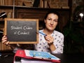 Young Woman holding a card in hands. Conceptual photo about Student Codes of Conduct with written text