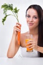 Young woman holding carrot and carrot juice Royalty Free Stock Photo