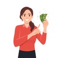 Young woman holding cash currency money in hand and pointing towards that Royalty Free Stock Photo