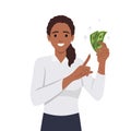 Young woman holding cash currency money in hand and pointing towards that Royalty Free Stock Photo