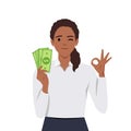 Young woman holding cash or currency or money in hand and showing OKAY or OK sign Royalty Free Stock Photo