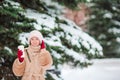 Beautiful girl with coffee to go outdoors on beautiful winter snow day Royalty Free Stock Photo