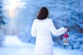 Young woman holding Christmas lantern outdoors on beautiful winter snow day Royalty Free Stock Photo