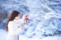 Young woman holding Christmas lantern outdoors on beautiful winter snow day Royalty Free Stock Photo