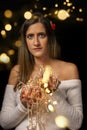 Young woman holding Christmas's string lights