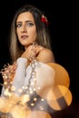 Young woman holding Christmas's string lights