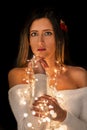 Young woman holding Christmas's string lights