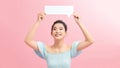 Young woman holding cloud speech bubble standing over isolated pink background with a happy face Royalty Free Stock Photo