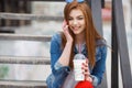 A young woman, holding a cocktail and making a phone call on a mobile phone Royalty Free Stock Photo