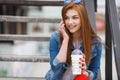 A young woman, holding a cocktail and making a phone call on a mobile phone Royalty Free Stock Photo