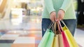 Young woman holding colorful shopping bags in shopping mall Royalty Free Stock Photo