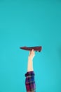 Young woman holding comfortable shoe on light blue background Royalty Free Stock Photo