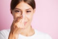 Young woman holding contact lens on finger. Royalty Free Stock Photo