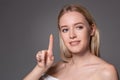 Young woman holding contact lens on index finger with copy space. Close up face of healthy beautiful woman about to wear Royalty Free Stock Photo