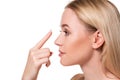 Young woman holding contact lens on index finger with copy space. Close up face of healthy beautiful woman about to wear Royalty Free Stock Photo