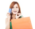 Young woman holding credit card with shopping bag Royalty Free Stock Photo