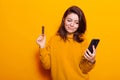 Young woman holding credit card to make purchase online Royalty Free Stock Photo