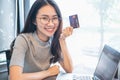 Young woman holding credit card and using laptop computer. Businesswoman or entrepreneur working. Online shopping, E-commerce. Int Royalty Free Stock Photo