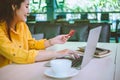 Young woman holding credit card and using laptop computer. Businesswoman working at cafe. Online shopping, e-commerce, internet Royalty Free Stock Photo