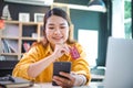 Young woman holding credit card and using laptop computer. Businesswoman working at cafe. Online shopping, e-commerce, internet Royalty Free Stock Photo